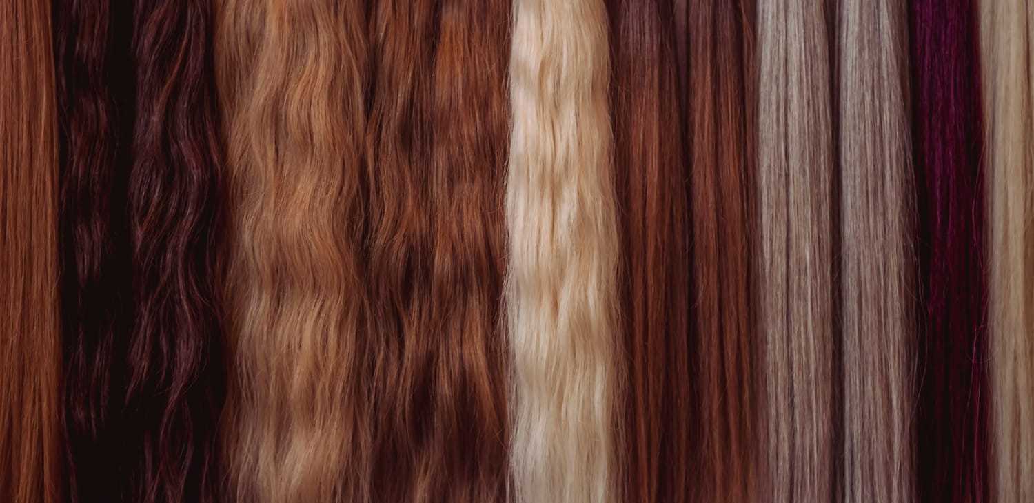 Various shades of brown, red, and blonde hair extensions displayed in vertical rows.