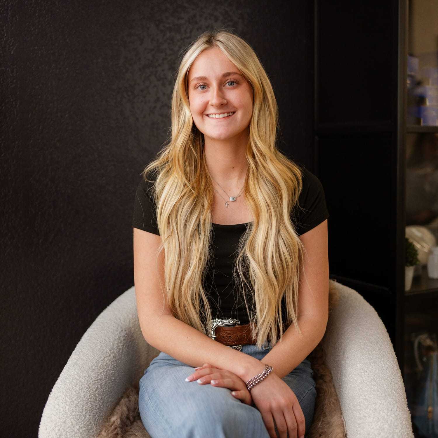 Portrait of Hailey Johnson, a professional stylist at Wisp Salon, showcasing their expertise and style.