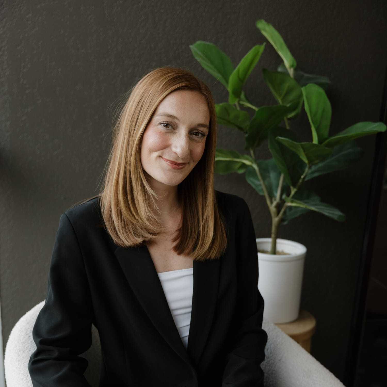 Portrait of Aubree Daniel, a professional stylist at Wisp Salon, showcasing their expertise and style.